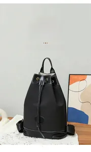 Detail of black Oxford fabric backpack featuring contrast stitching and drawstring closure