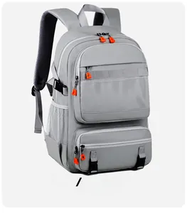 Detail of grey travel backpack featuring orange zippers and water-resistant fabric