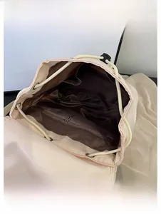 Detail view of large capacity backpack interior featuring satin lining and multiple pockets
