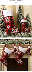 Detail of red and black buffalo plaid Christmas stockings with white snowflake prints