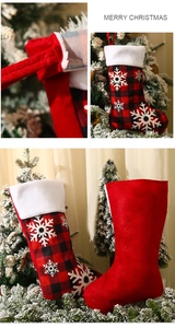 Detail of red and black buffalo plaid Christmas stocking with snowflake embroidery and plush trim