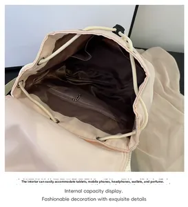 Top view of pink backpack interior with large capacity, drawstring closure and silk lining