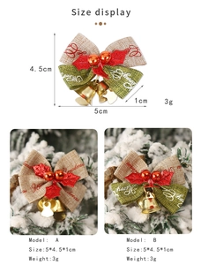 Macro shot of 5cm Christmas bow with iron bells and Merry print on pine branches