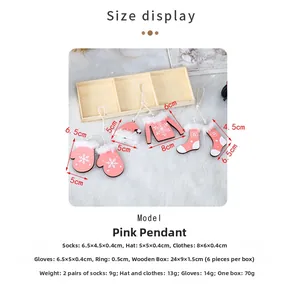 Detail of pink wooden Christmas ornaments set in a natural wooden storage box
