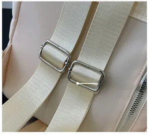 Detail view of the durable nylon shoulder strap and adjustable silver metal buckles