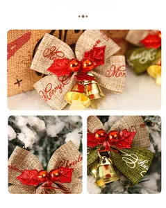 Detail of Christmas bow decoration with Merry Christmas text, red berries and gold bells