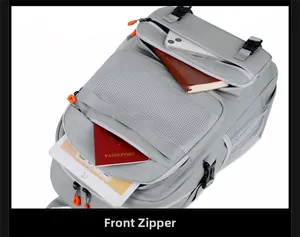 Front zipper compartment of gray travel backpack showing multi-pocket storage for passports