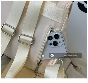 Detail view of water-resistant nylon backpack featuring back anti-theft zipper pocket
