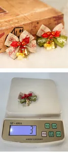 Close-up of burlap Christmas bows with gold bells and Merry Christmas print