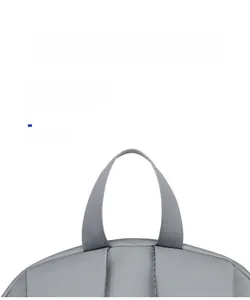 Close-up of durable fabric handle and reinforced stitching on a gray travel backpack