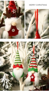 Close-up of handmade Christmas gnome ornaments with reindeer antlers and striped hats