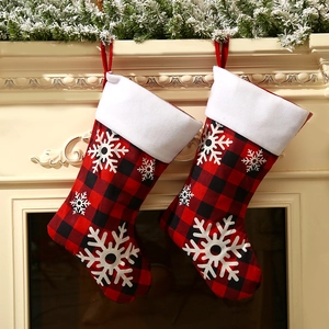 Set of 2 red black plaid Christmas stockings with white snowflakes and plush cuffs