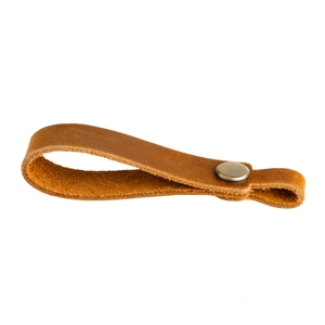 Macro detail of crazy horse leather keychain with retro round metal snap button