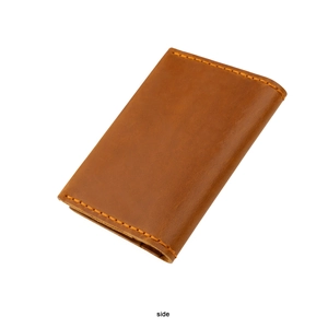 Detail view of brown crazy horse leather card holder with orange stitching and side view