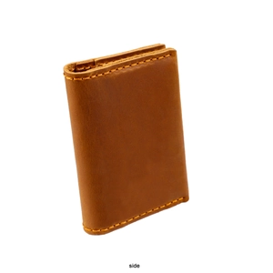 Side view of brown crazy horse leather card holder with detailed yellow stitching