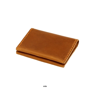 Side view detail of brown crazy horse leather card holder with contrast stitching