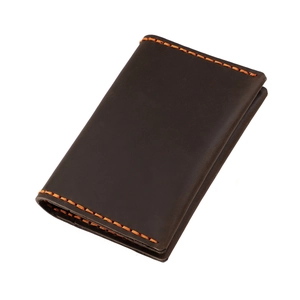 Detail of crazy horse leather card holder with contrast orange hand-stitched seams