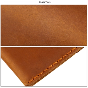 Macro detail of brown leather texture and yellow hand-stitched seams on the wallet edge