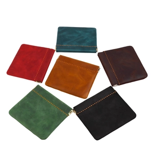 Macro view of six colorful crazy horse leather coin purses with metallic spring closures