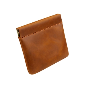 Detail of crazy horse leather coin purse showing vintage texture and metal spring closure