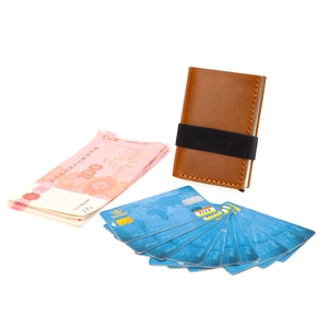 Detail of crazy horse leather wallet with orange stitching and elastic band closure