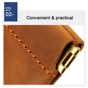 Detail of brown crazy horse leather pouch with orange stitching and gold metal clasp