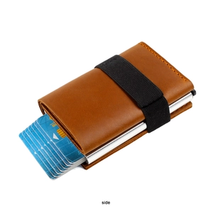 Detailed side view of brown crazy horse leather wallet with pop-up card mechanism and strap