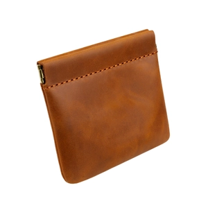 Detailed view of brown crazy horse leather coin purse with squeeze metal spring closure