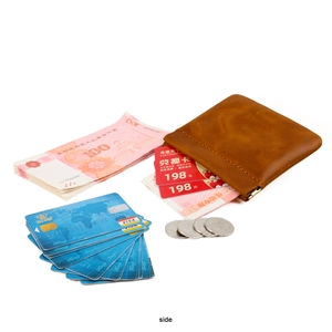 Brown leather coin pouch detail with metal spring closure and card storage capacity