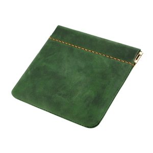 Macro detail of dark green crazy horse leather coin purse with orange stitching