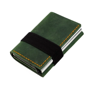 Detail of crazy horse leather wallet featuring orange stitching and elastic band