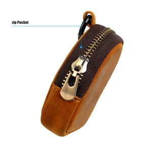 Detail view of vintage crazy horse leather coin purse with bronze zipper and metal clip
