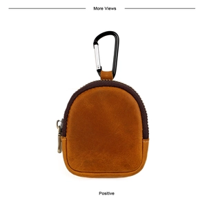 Detailed view of a retro brown leather coin purse with stitching and metal carabiner