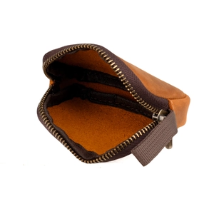 Macro detail of genuine leather coin pouch showing the metal zipper and internal texture