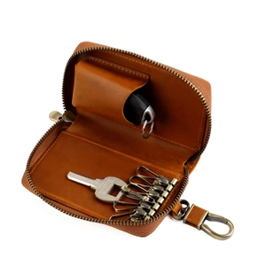 Interior detail of vintage leather car key case with 6 hooks and metal zipper closure