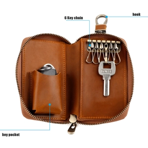 Detail of crazy horse leather key case featuring 6 metal hooks and a side pocket