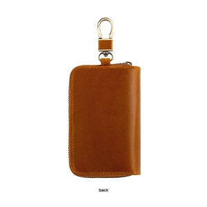 Macro view showing back side of vintage brown leather car key bag with copper metal hook