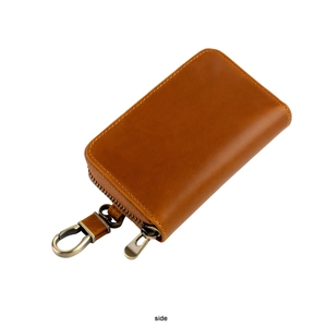 Side view showing polished metal zipper and hook on vintage brown leather car key case