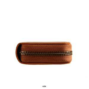 Detail view of vintage crazy horse leather car key case with brass zipper and fine stitching