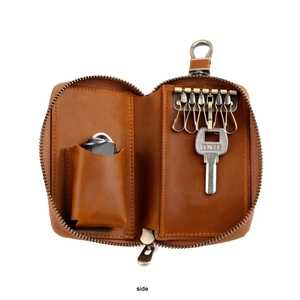 Interior detail of vintage leather key pouch with six bronze hooks and card holder