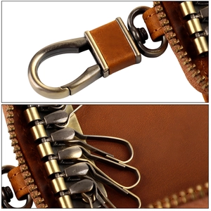 Close-up of bronze swivel hook and six internal key rings on vintage leather case