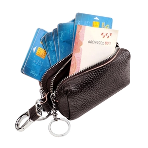 Detailed interior view of brown pebbled leather key pouch holding cards and cash