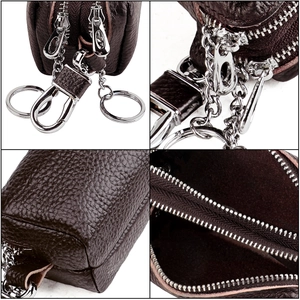 Macro view of dual-zipper leather key case showing litchi texture and metal hook