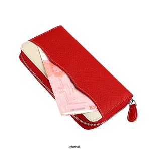 Internal view of a red leather wallet showing bill slot and pebble grain texture