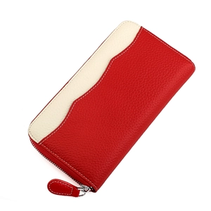 Close-up of red pebbled leather long wallet featuring contrast stitching and zip closure