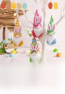 Detailed view of four colorful Easter gnome plush hangers with rabbit ears on a white tree