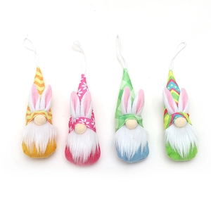 Four Easter gnome hanging ornaments with rabbit ears and colorful patterned pointed hats