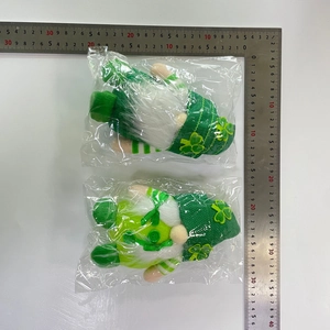 Close-up of Saint Patrick's Day gnomes with green shamrock hats and measurement scale