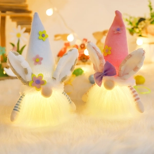 Lighted Easter bunny gnomes set with glowing warm light and knitted flower hats