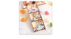 Close-up of wooden Easter truck pendants with bunnies and eggs on white faux fur background
